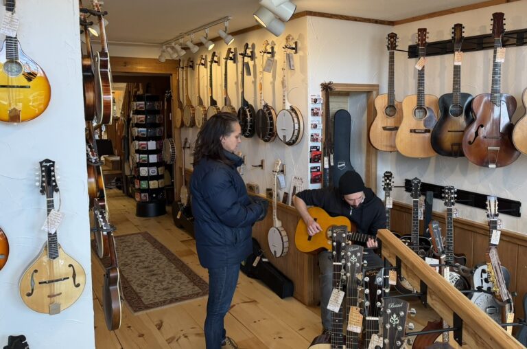 Bob trying out guitars Island City Acoustics
