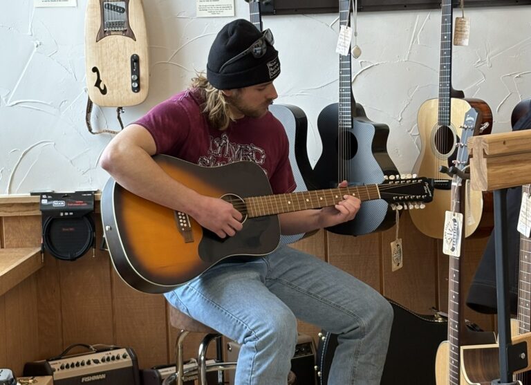 Trying out guitars at Island City Acoustics