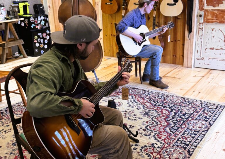 Trying out guitars in the back room Island City Acoustics